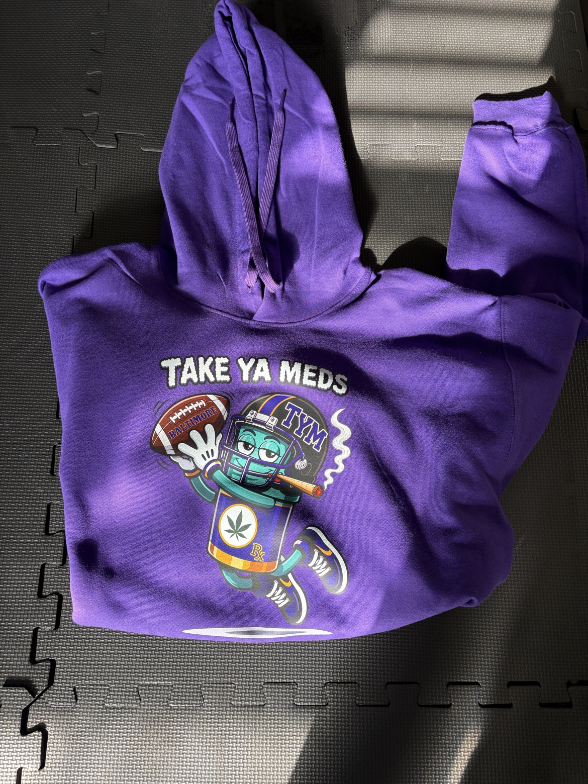 Baltimore Mascot Hoodie — purple hoodie with the Take Ya Meds mascot